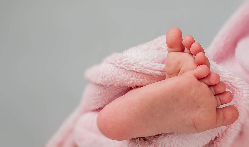 baby feet wrapped in a towel