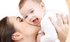 Mother kissing baby